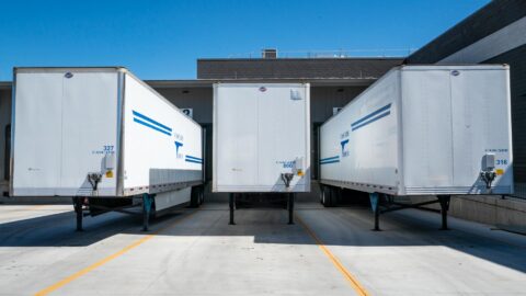 three white enclosed trailers