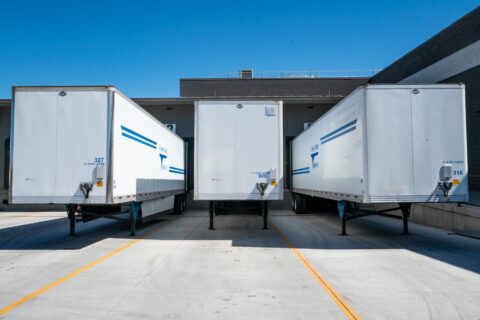three white enclosed trailers