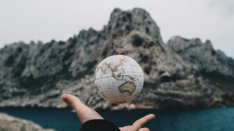 person tossing globe