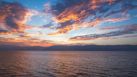 body of water under cloudy sky during daytime