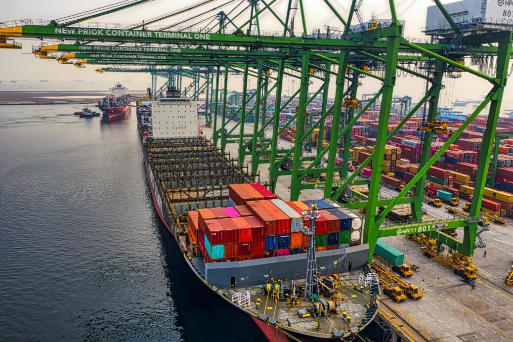 blue and red cargo ship on dock