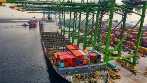 blue and red cargo ship on dock