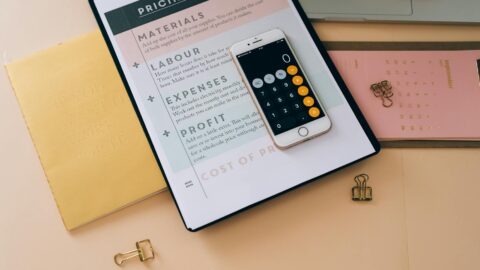 white mobile phone on black clipboard with white paper